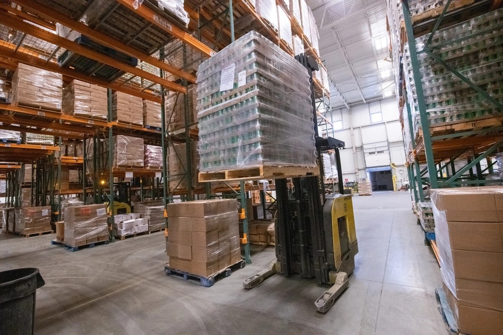 Warehouse racking with a forklift operator managing pallets