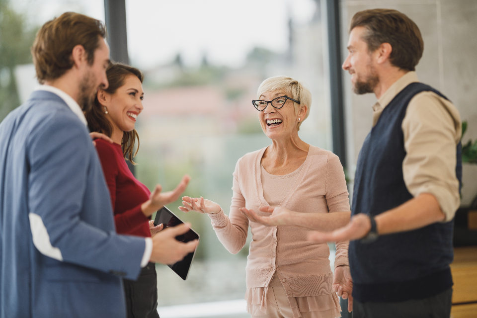 Colleagues talking and smiling in an office